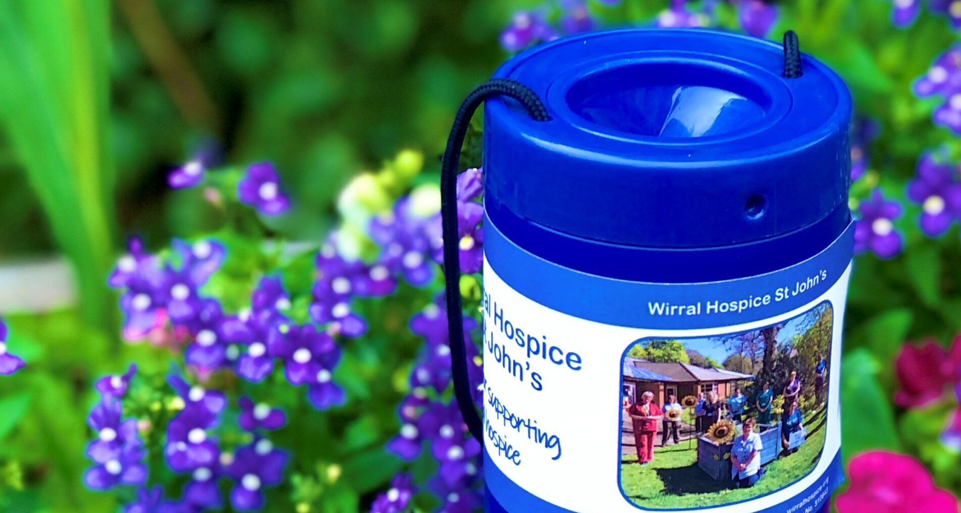 https://www.wirralhospice.org/wp-content/uploads/2022/11/collection-box-purple-pink-flowers-scaled-e1712308818771.jpg